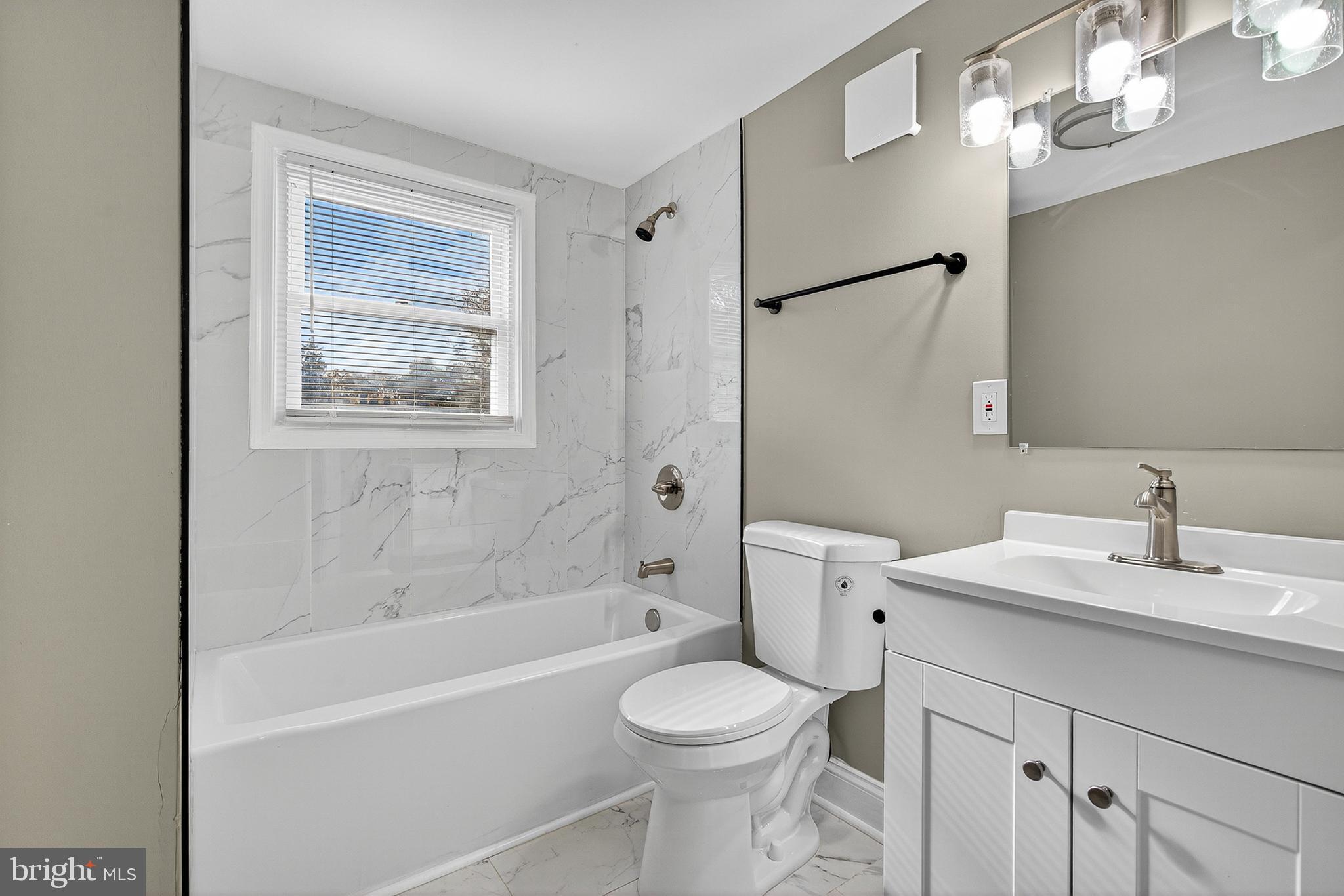 3310 Glen Avenue Baltimore, MD 21215 - Photo 18 of 33 a bathroom with a sink a toilet and shower