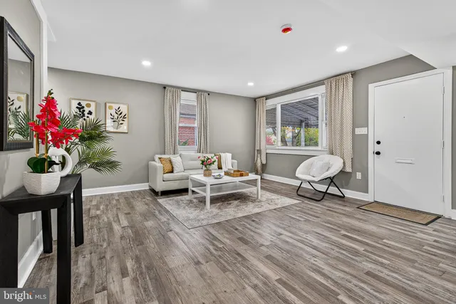 a living room with furniture and a potted plant