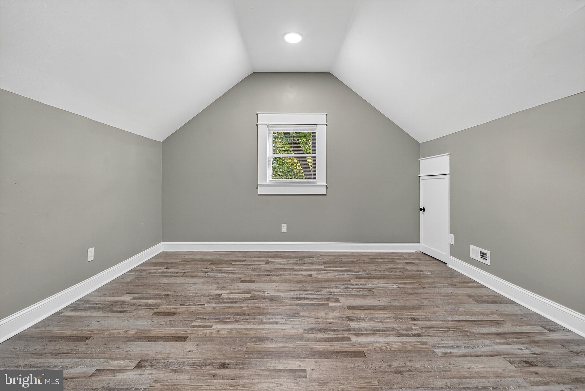 3310 Glen Avenue Baltimore, MD 21215 - Photo 21 of 33 a view of an empty room with wooden floor and a window