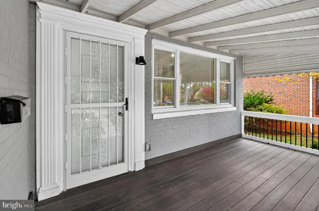 a view of a room with wooden floor and windows