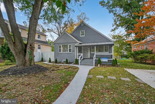 a front view of a house with yard patio and green space