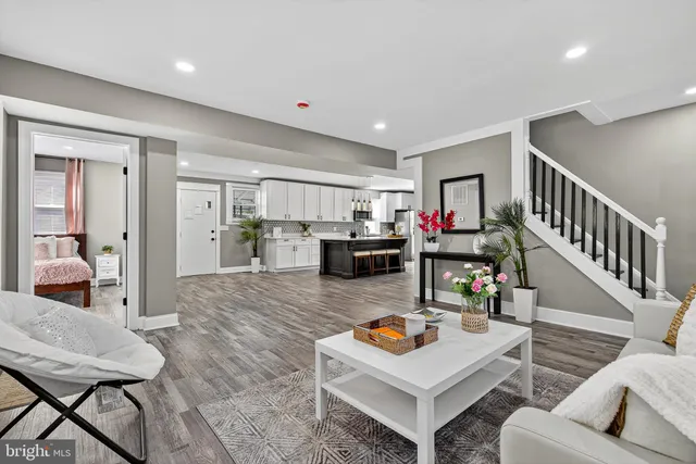 a living room with furniture and a wooden floor