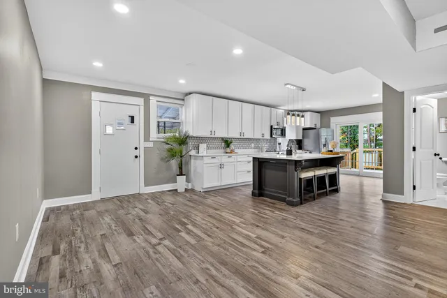 a kitchen with stainless steel appliances a refrigerator sink and cabinets