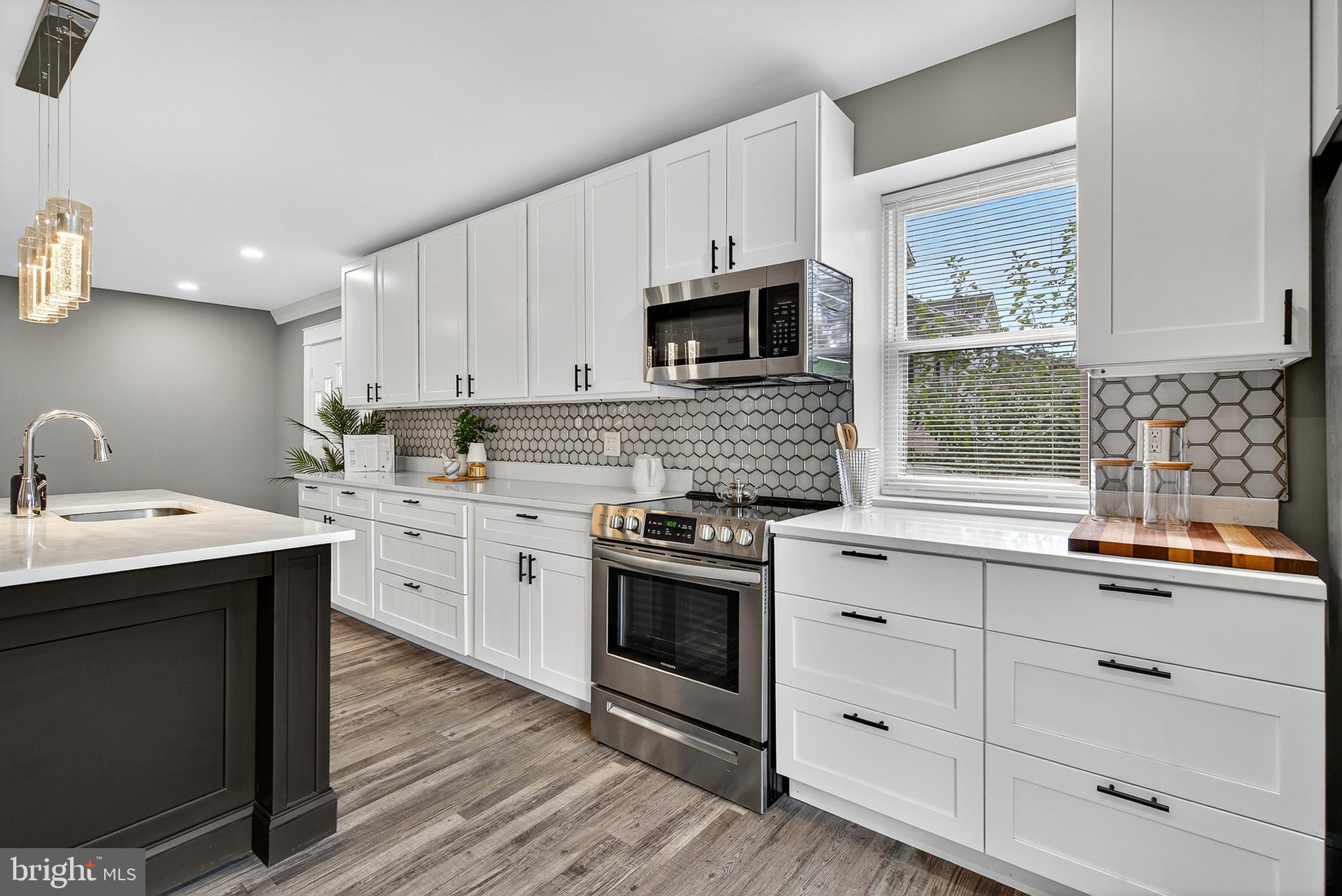 3310 Glen Avenue Baltimore, MD 21215 - Photo 9 of 33 a kitchen with stainless steel appliances granite countertop a sink a stove and cabinets