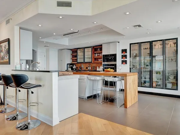 a kitchen with stainless steel appliances kitchen island granite countertop a stove and cabinets