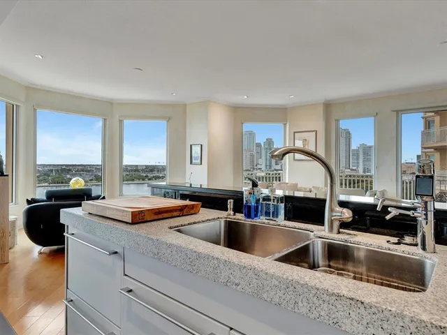 a kitchen with sink a refrigerator and cabinets