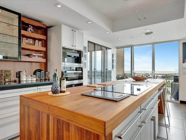 a kitchen with a stove a sink and a refrigerator
