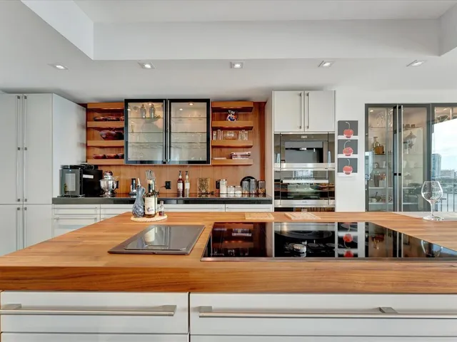 a kitchen with stainless steel appliances granite countertop a stove and more cabinets