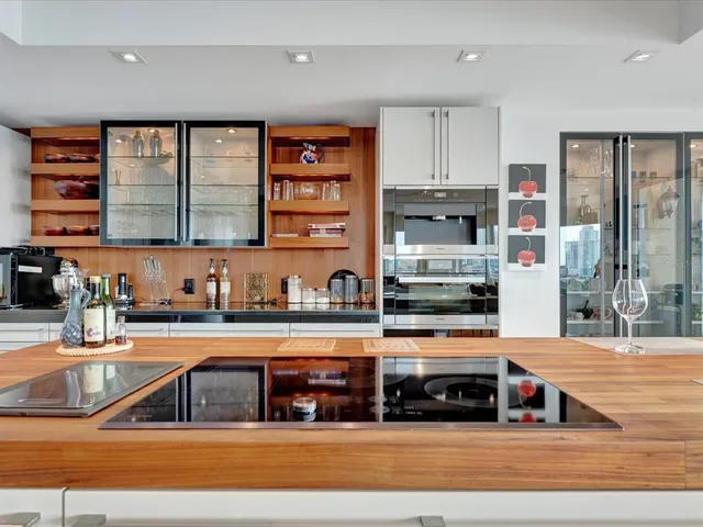 a kitchen with stainless steel appliances granite countertop a stove and a sink