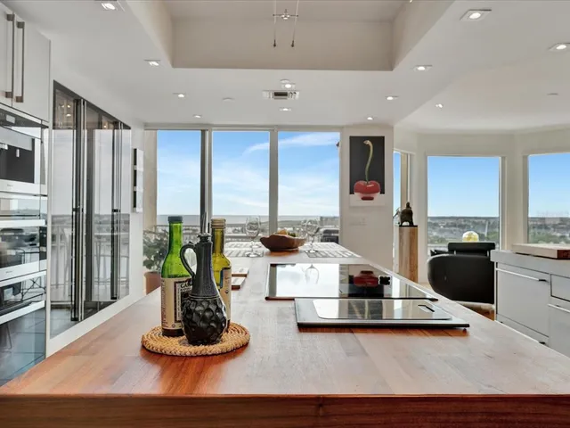 a kitchen with stainless steel appliances kitchen island granite countertop a stove and a sink