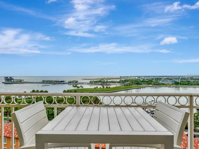 a view of roof deck with outdoor seating and city view