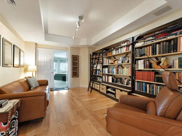 a living room with furniture cabinets and a book shelf