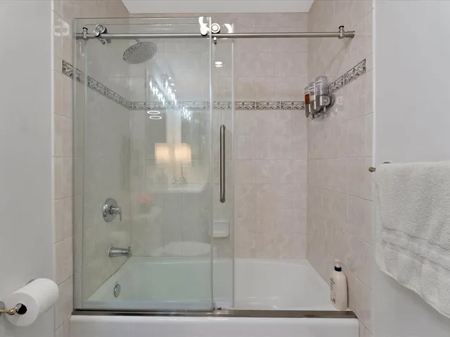 a bathroom with a glass shower door