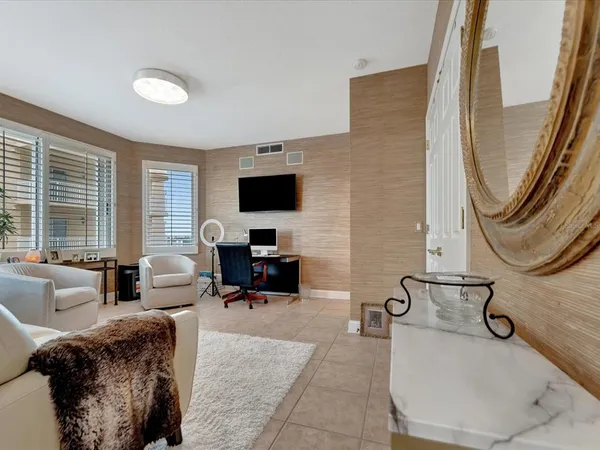 a view of a livingroom with workspace and a couch