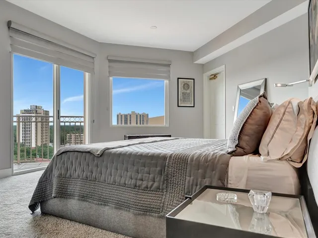 a bedroom with a large bed and a large window