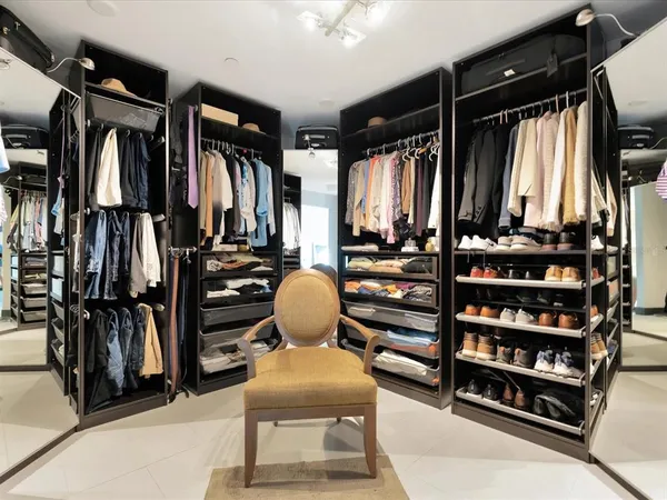 a view of walk in closet with clothes and shoes