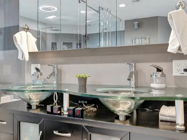 a kitchen with stainless steel appliances granite countertop a sink and white cabinets