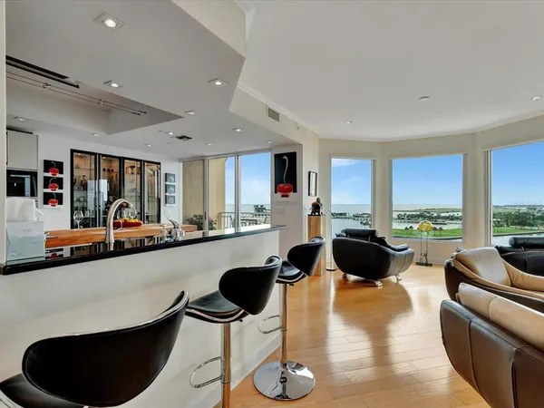 a living room with furniture a rug and a large window