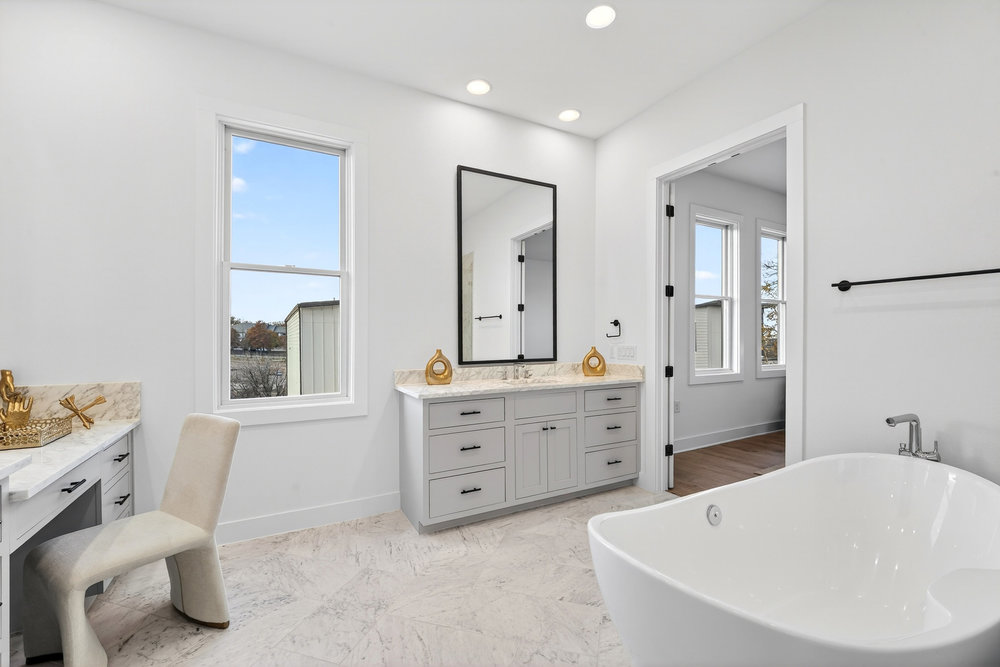 2707 Salek View Austin, TX 78741 - Photo 23 of 39 Full bathroom with a soaking tub, vanity, recessed lighting, and light marble finish floors