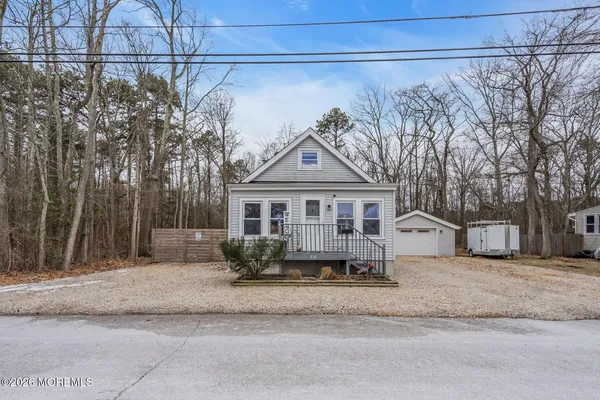 a view of a house with a yard covered in snow