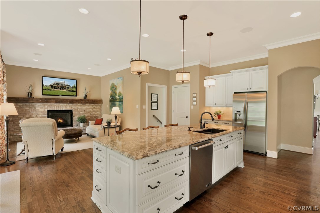 13430 Stonegate Road Midlothian, VA 23113 - Photo 11 of 35 a kitchen with stainless steel appliances granite countertop a stove a sink and a wooden floor