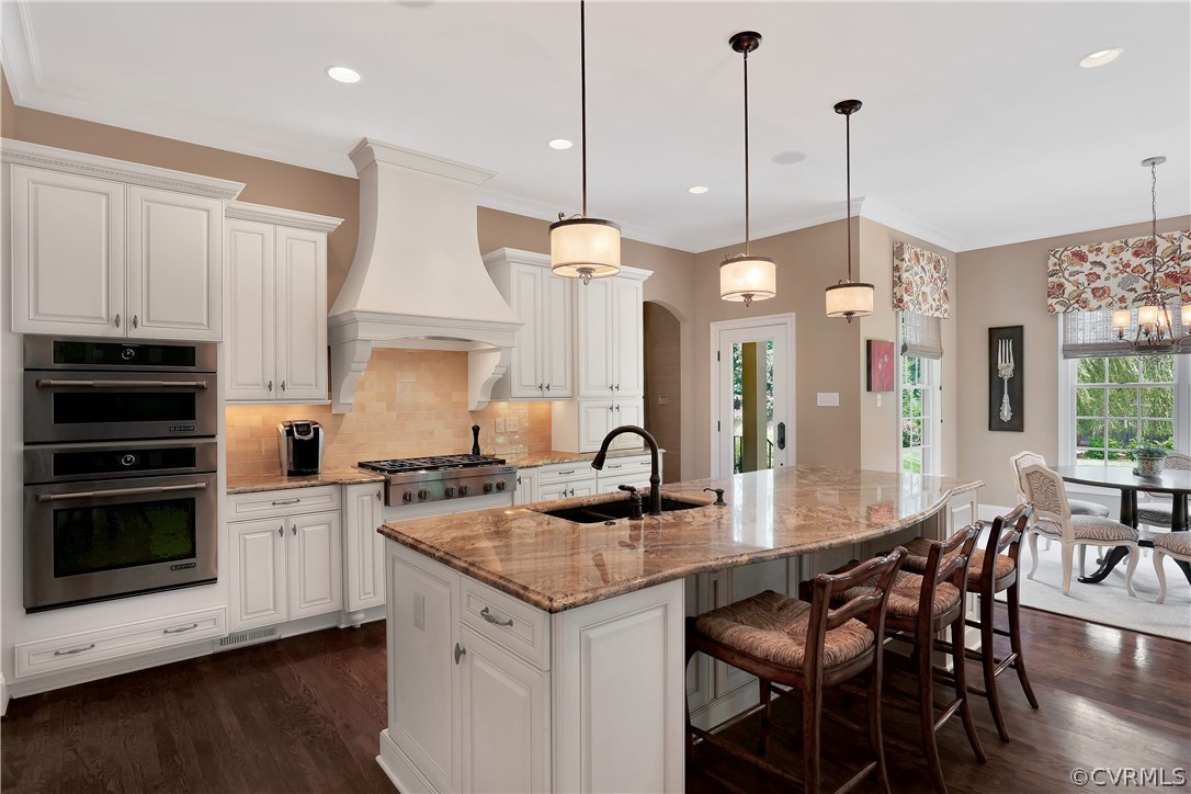 13430 Stonegate Road Midlothian, VA 23113 - Photo 13 of 35 a kitchen with stainless steel appliances granite countertop a stove a kitchen island a white cabinets and chairs
