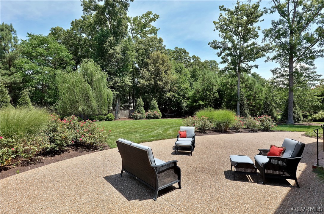 13430 Stonegate Road Midlothian, VA 23113 - Photo 32 of 35 a view of a patio with couches and a table and chairs with plants and trees