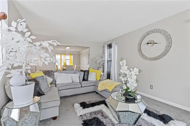 a living room with furniture flowerpot and wooden floor