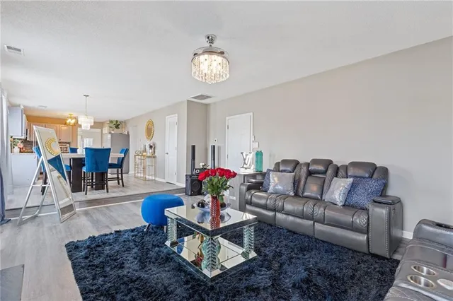 a living room with furniture and wooden floor