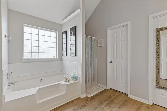 a bathroom with a bathtub and shower