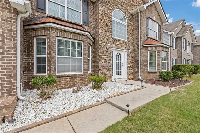 a front view of a house with garden
