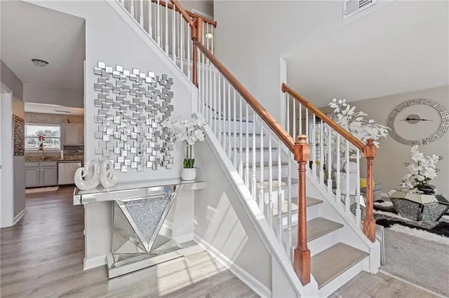 a view of entryway and hall with wooden floor