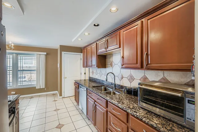 a kitchen with stainless steel appliances granite countertop a sink stove and cabinets