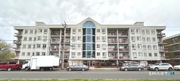 a front view of a residential apartment building with a yard
