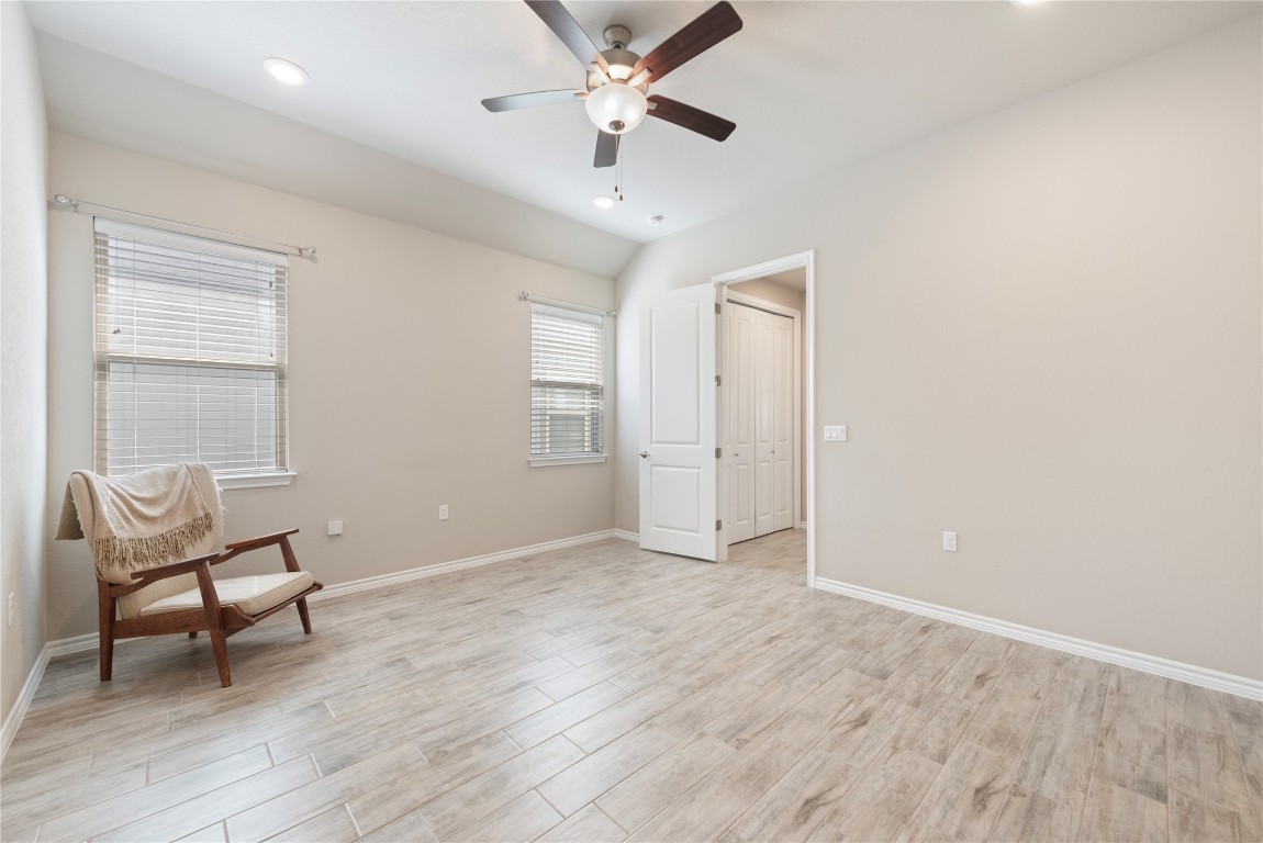 121 Bolivar Way, Unit 101 San Marcos, TX 78666 - Photo 12 of 33 an empty room with wooden floor and windows