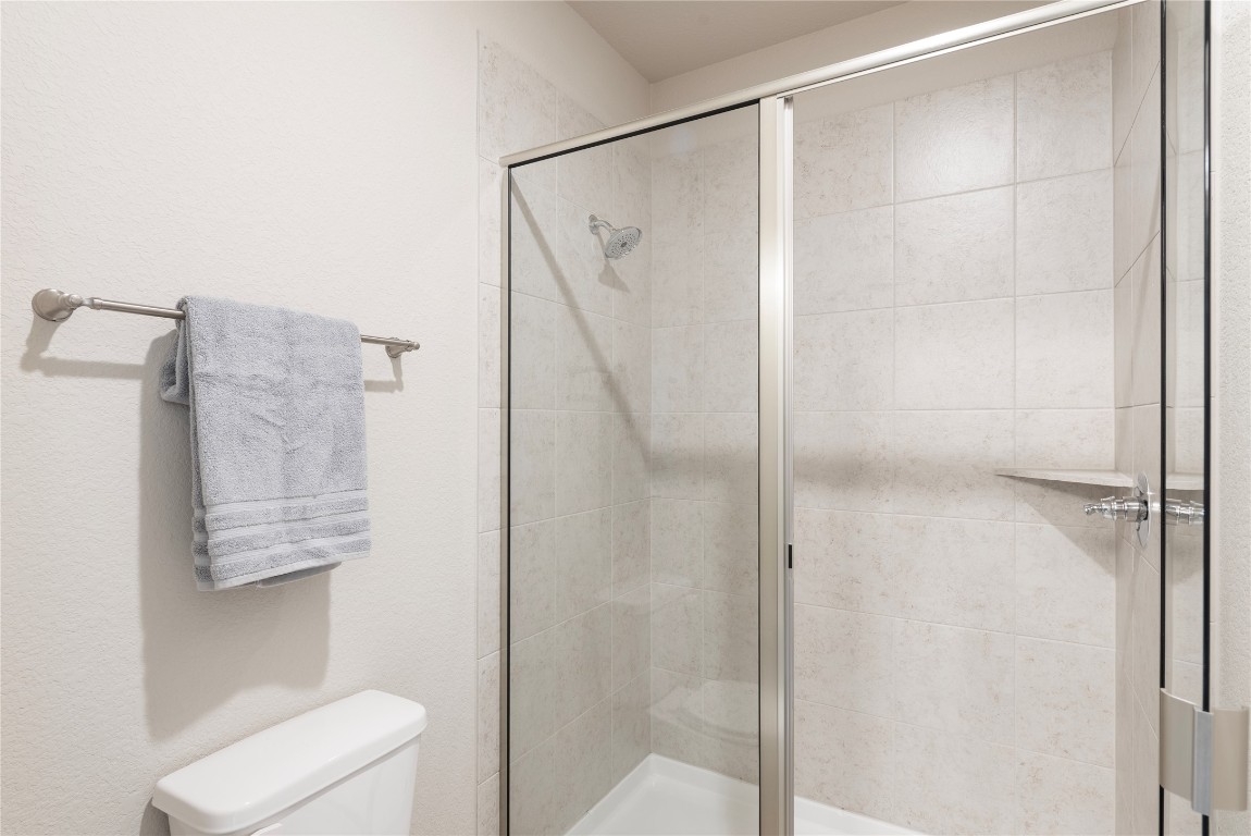 121 Bolivar Way, Unit 101 San Marcos, TX 78666 - Photo 17 of 33 a bathroom with a shower and toilet