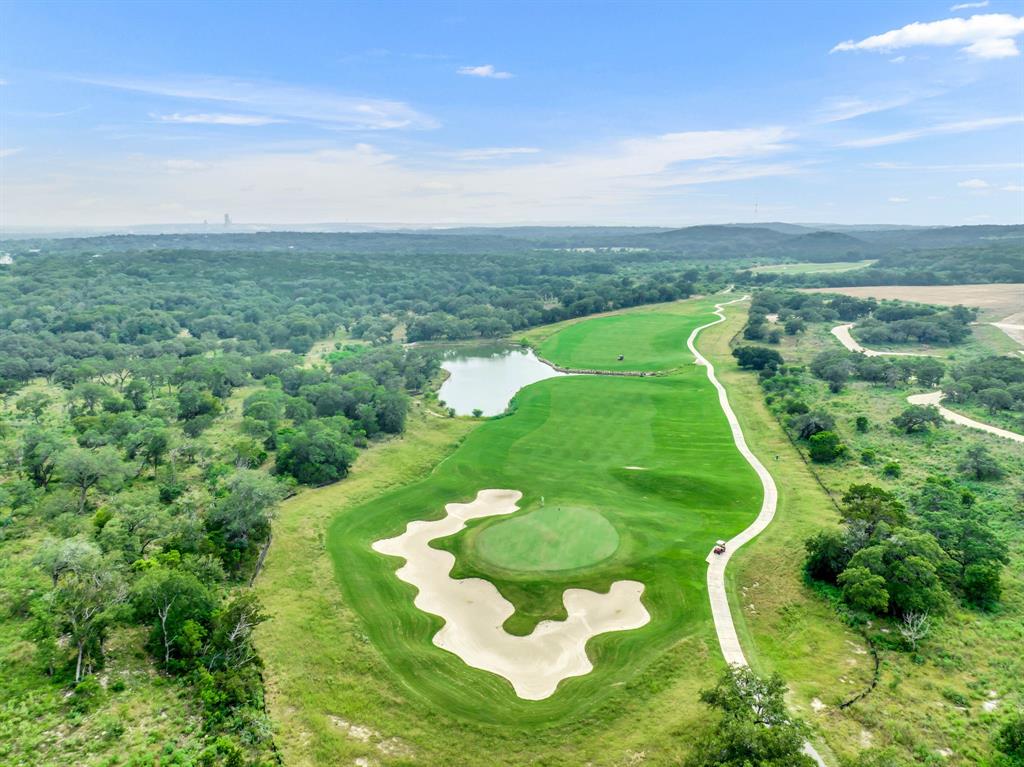 121 Bolivar Way, Unit 101 San Marcos, TX 78666 - Photo 25 of 33 a view of a golf course with a lake