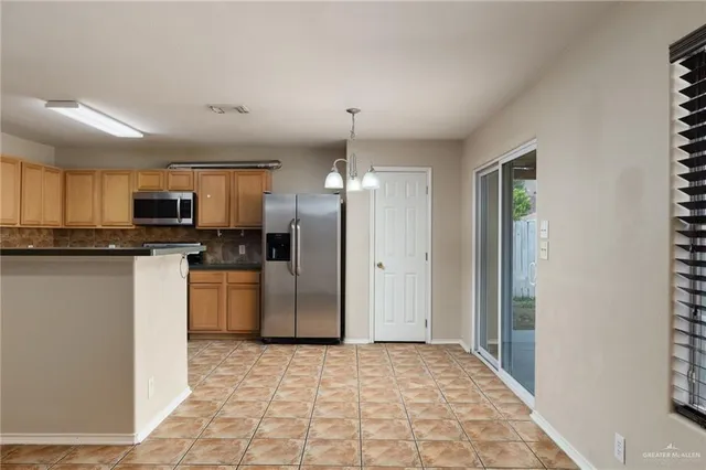 a view of a kitchen with a sink and a refrigerator