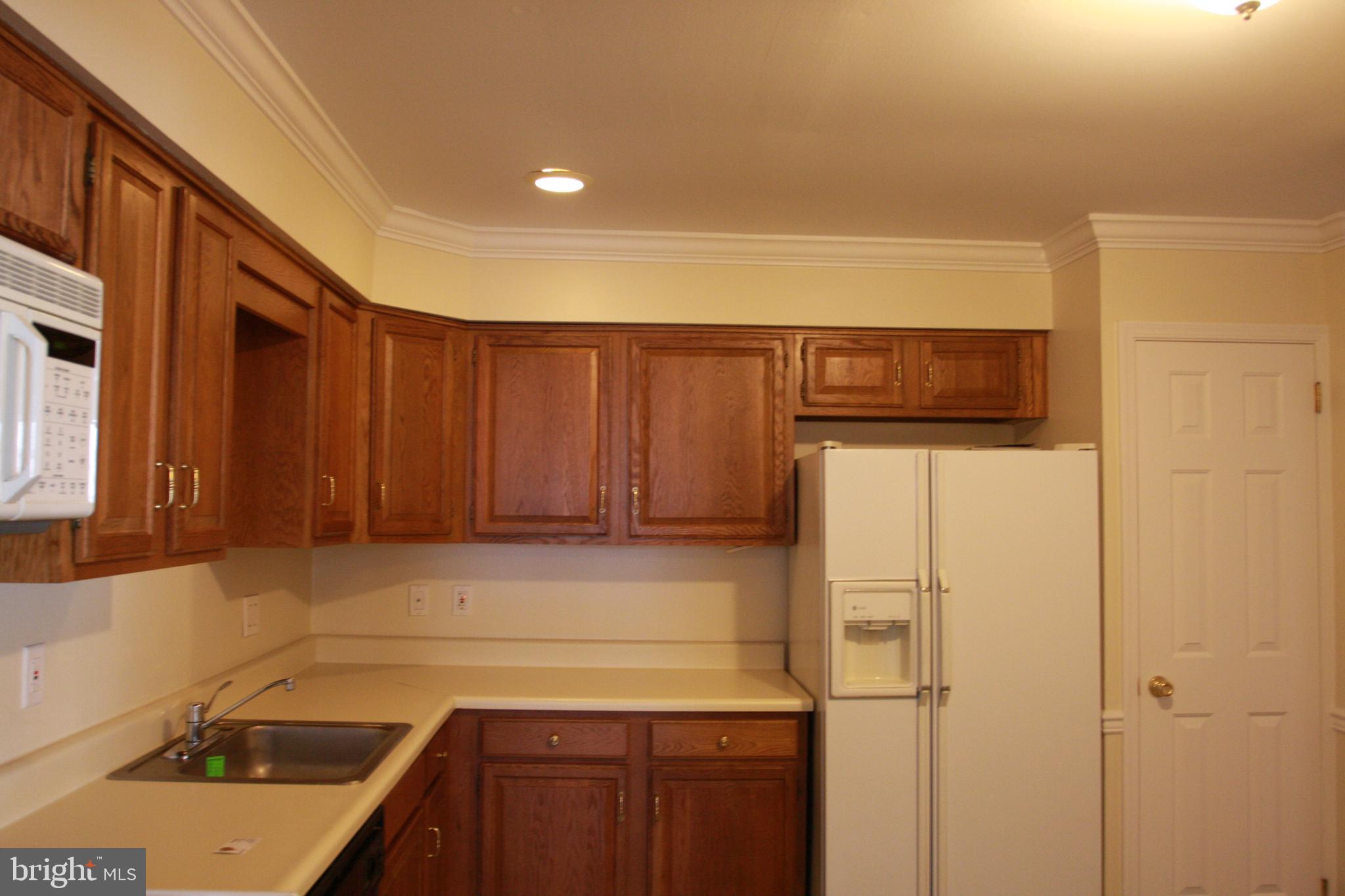 1195 Heyward Road, Unit 36 Chesterbrook, PA 19087 - Photo 5 of 15 a kitchen with a sink a refrigerator and cabinets