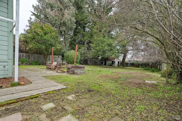 a view of a chair and table in the garden