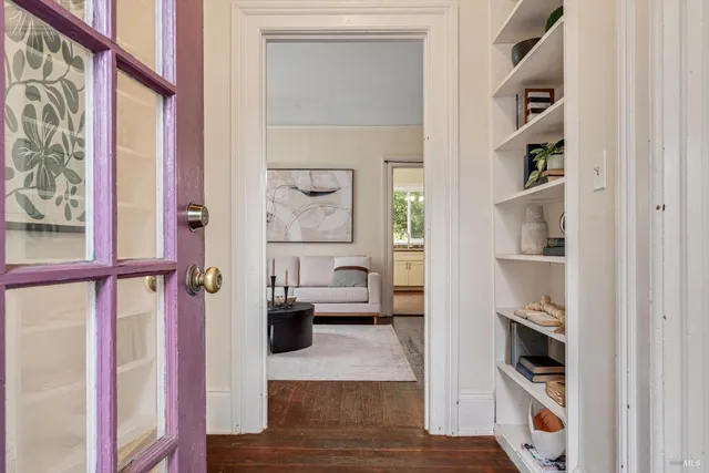 a living room with furniture and a book shelf