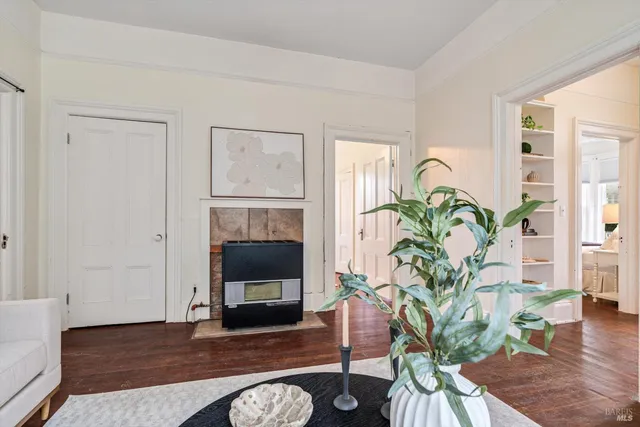 a living room with furniture fireplace and wooden floor