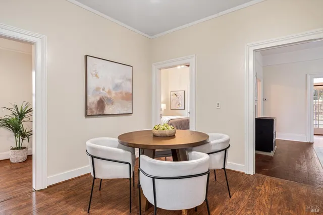 a dining room with furniture and wooden floor