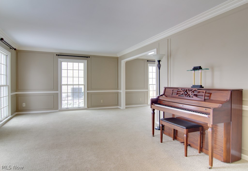 L-shaped formal Living room/Dining room - perfect for entertaining. Exceptional floor to ceiling Pella windows, wainscot, plaster crown molding.

