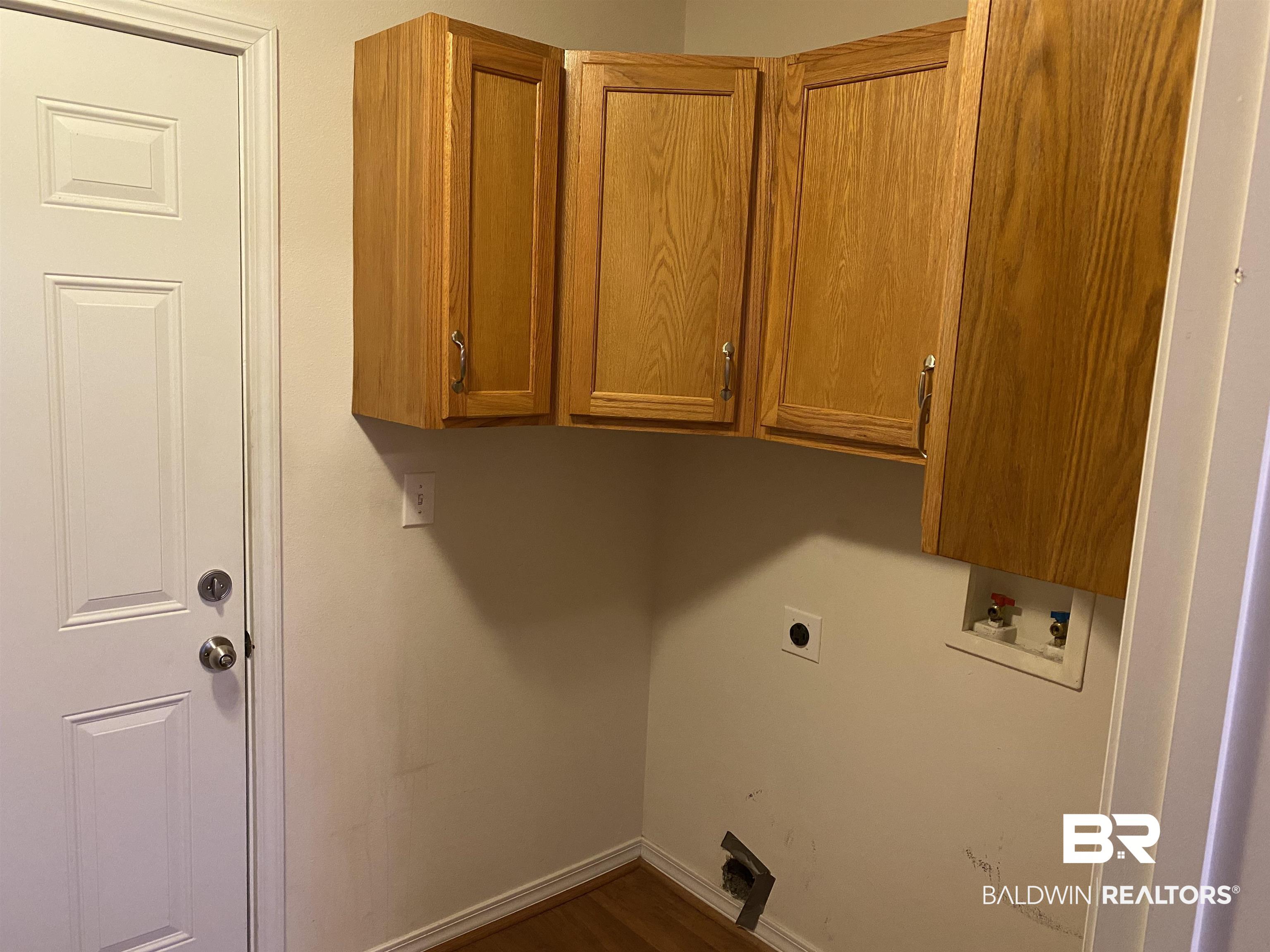 7742 Avery Lane Daphne, AL 36526 - Photo 29 of 41 Laundry Room and Cabinets