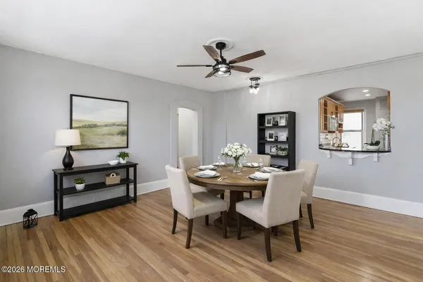 a view of a dining room with furniture window and wooden floor