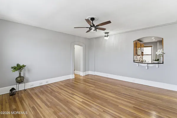 a view of empty room with wooden floor