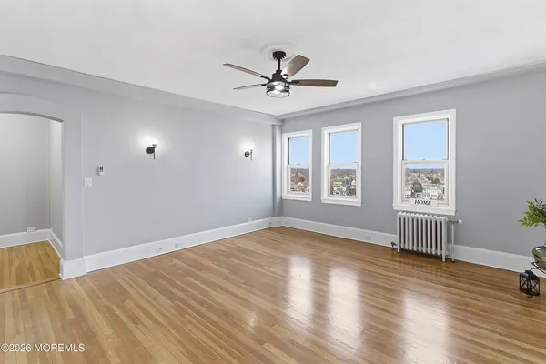 wooden floor in an empty room with a window