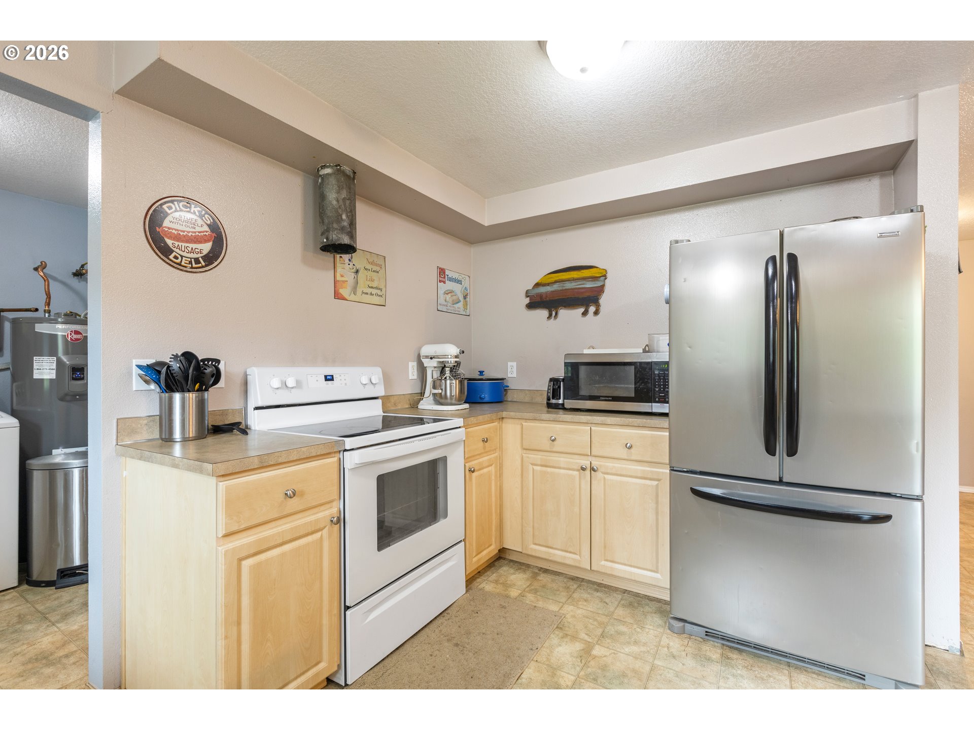 220 Southeast Wells Road Oakland, OR 97462 - Photo 18 of 45 a kitchen with stainless steel appliances granite countertop a refrigerator a stove and a sink with wooden floor