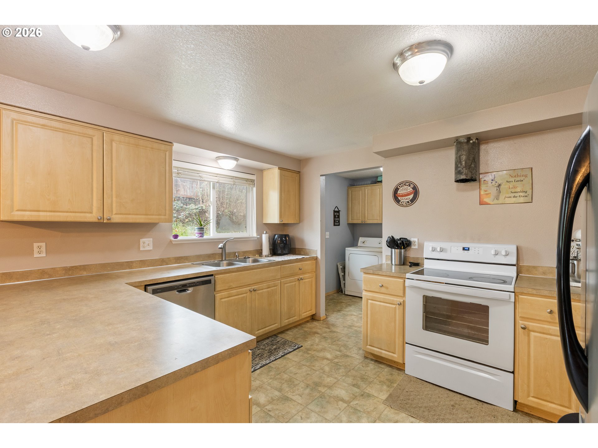 220 Southeast Wells Road Oakland, OR 97462 - Photo 23 of 45 a kitchen with a stove a sink and a refrigerator